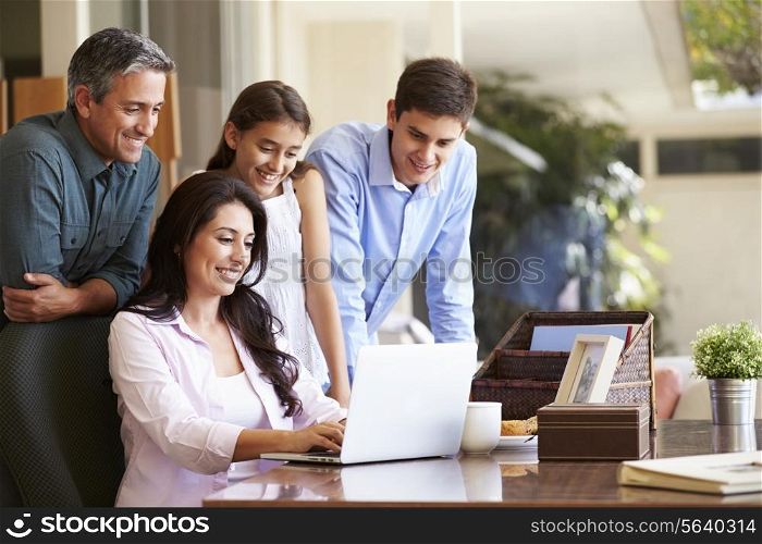 Family Looking At Laptop Together