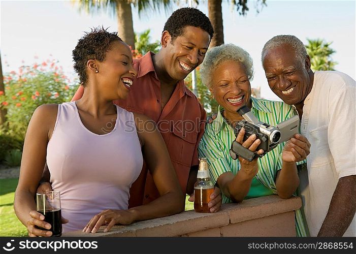 Family Looking at Video Camera at Barbecue
