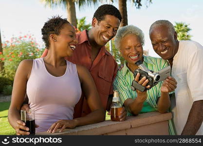 Family Looking at Video Camera at Barbecue