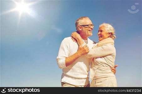 family, love and people concept - happy senior couple hugging outdoors