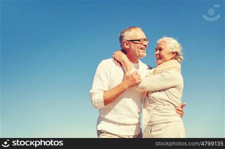 family, love and people concept - happy senior couple hugging outdoors