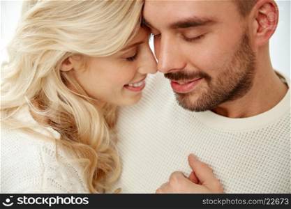 family, love, winter and people concept - close up of happy couple faces with closed eyes