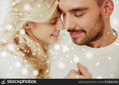 family, love, winter and people concept - close up of happy couple faces with closed eyes