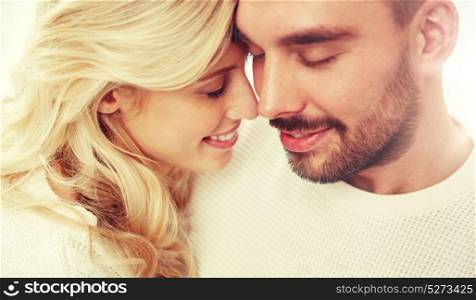 family, love, winter and people concept - close up of happy couple faces with closed eyes. close up of happy couple faces with closed eyes