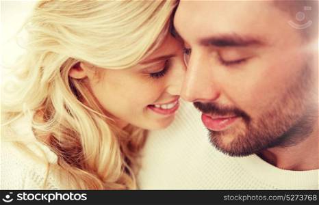 family, love, winter and people concept - close up of happy couple faces with closed eyes. close up of happy couple faces with closed eyes