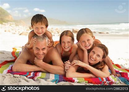 Family lying on beach.