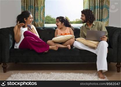 Family members spending their leisure time with various gadgets at home