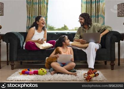 Family members spending their leisure time with various gadgets at home