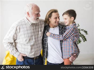 family men different generations hugging together