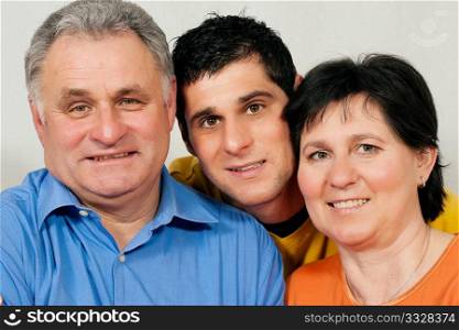 Family - mother, father, and adult son looking at each other