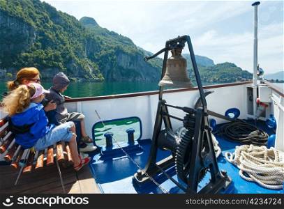Family (mother with children) have excursion by Lake Como (Italy) summer view on ship board
