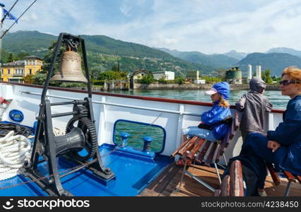 Family (mother with children) have excursion by Lake Como (Italy) summer view on ship board