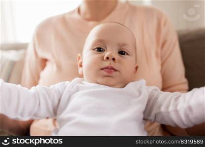 family, motherhood and people concept - close up of mother with little baby boy at home. close up of mother with little baby boy at home