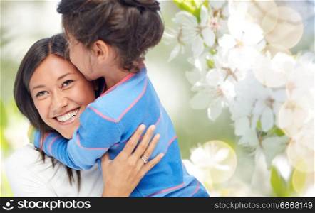 family, motherhood and people concept - happy mother and daughter hugging and kissing over cherry blossom background. happy mother and daughter hugging and kissing. happy mother and daughter hugging and kissing