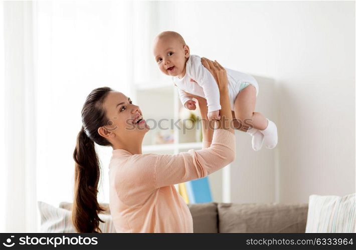 family, motherhood and people concept - happy mother playing with little baby boy at home. happy mother playing with little baby boy at home