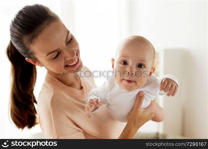 family, motherhood and people concept - happy mother playing with little baby boy at home. happy mother playing with little baby boy at home