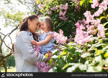family, motherhood and people concept - happy mother with little daughter at summer park or garden. happy mother with little daughter at summer park