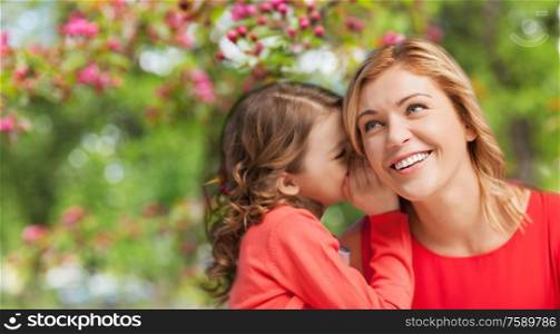 family, motherhood and people concept - happy smiling mother and daughter whispering her secret over cherry blossom background. happy mother and daughter whispering her secret