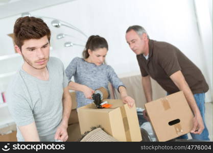 family moving into a new home carrying their stuff