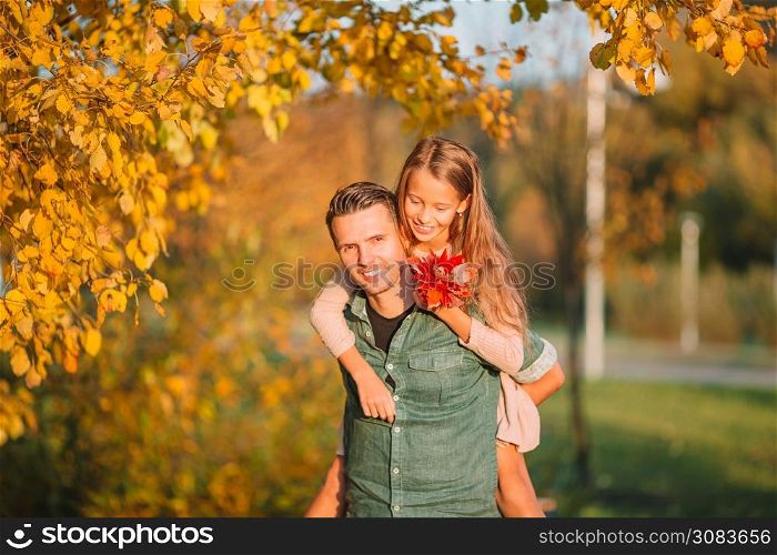 Family of dad and his daughter together in autumn park. Family of dad and kid on beautiful autumn day in the park