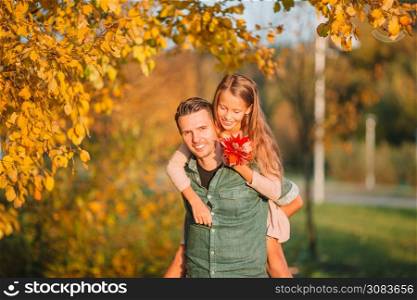 Family of dad and his daughter together in autumn park. Family of dad and kid on beautiful autumn day in the park
