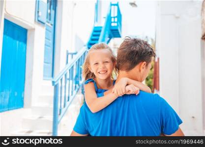Family of father and little kid on summer greek vacation outoors. Happy dad and little adorable girl traveling in Mykonos, Greece