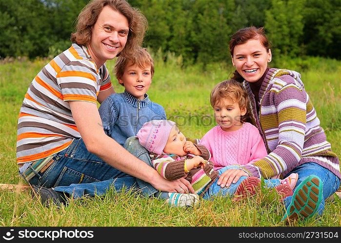Family of five portrait on grass