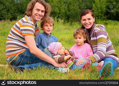 Family of five portrait on grass