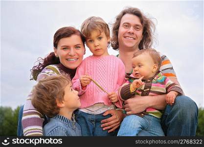 Family of five portrait on nature