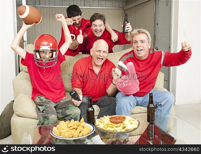 Family of football fans cheering for their favorite team.