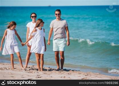 Family of four on the beach vacation. Young family on vacation have a lot of fun