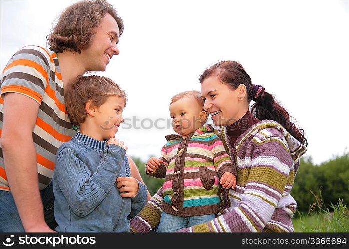 Family of four portrait on nature