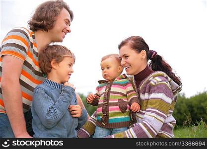 Family of four portrait on nature