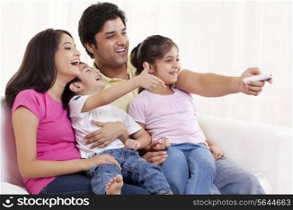 Family of four watching television