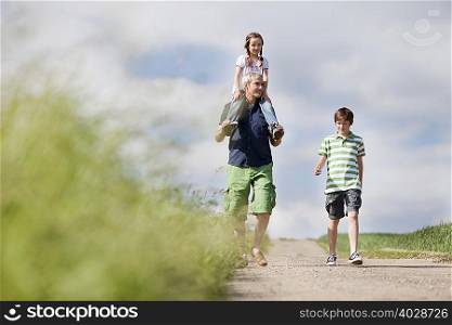 family of three walking down the road