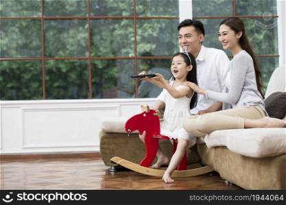 Family of three watching TV