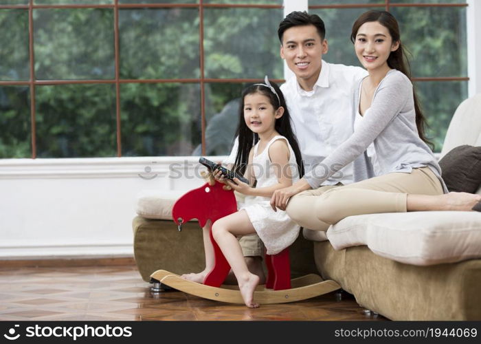 Family of three watching TV