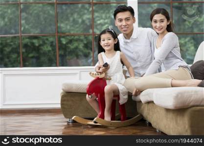 Family of three watching TV