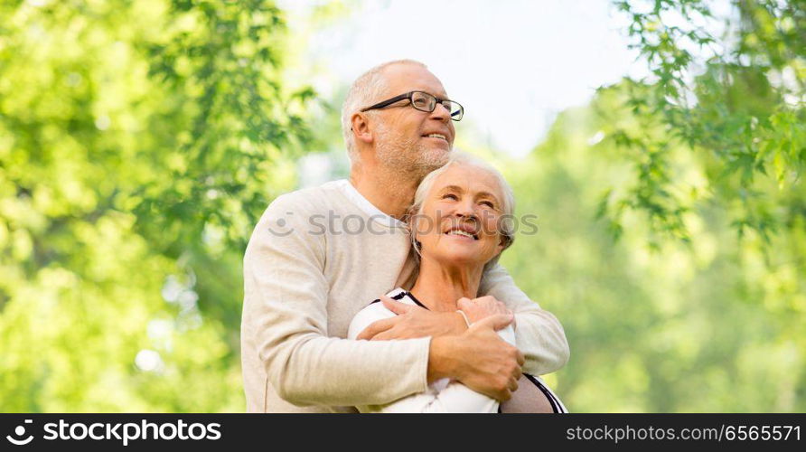 family, old age and relationships concept - happy senior couple over green natural background. happy senior couple over green natural background