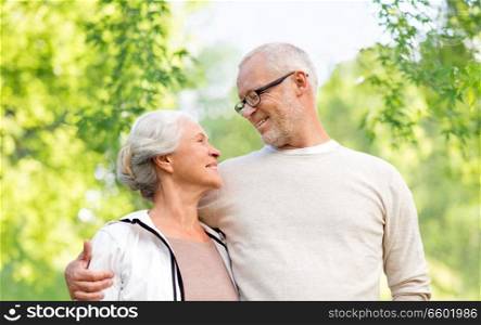 family, old age and relationships concept - happy senior couple over green natural background. happy senior couple over green natural background