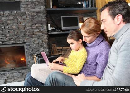 Family on a sofa in front of the fireplace