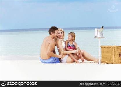 Family On Beach With Luxury Champagne Picnic
