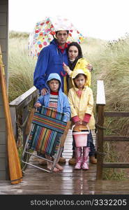 Family on beach with umbrella