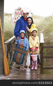 Family on beach with umbrella