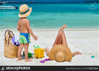 Family on beach, woman with three year old boy. Summer vacation at Maldives.