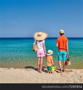 Family on beach, young couple with three year old boy. Sithonia, Greece