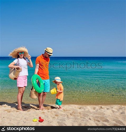 Family on beach, young couple with three year old boy. Sithonia, Greece
