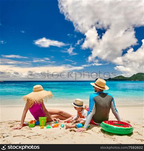 Family on beach, young couple with three year old boy. Summer vacation at Seychelles.