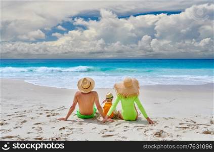Family on beach, young couple with three year old boy. Summer vacation at Seychelles.