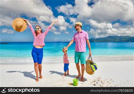 Family on beautiful Anse Soleil beach, young couple with three year old toddler boy. Summer vacation at Seychelles, Mahe.